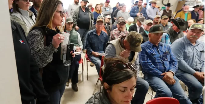Christy Oats, left, talks at a U.S. Department of Agriculture informational meeting for farmers and ranchers affected by the Panhandle wildfires at the Hemphill County Exhibition Center in Canadian on March 5. Credit: Mark Rogers for The Texas Tribune